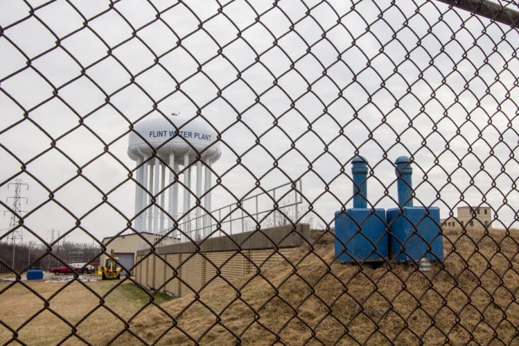 Flint, Michigan water tower behind chain link fence