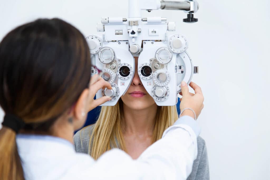Woman receives eye examination from doctor