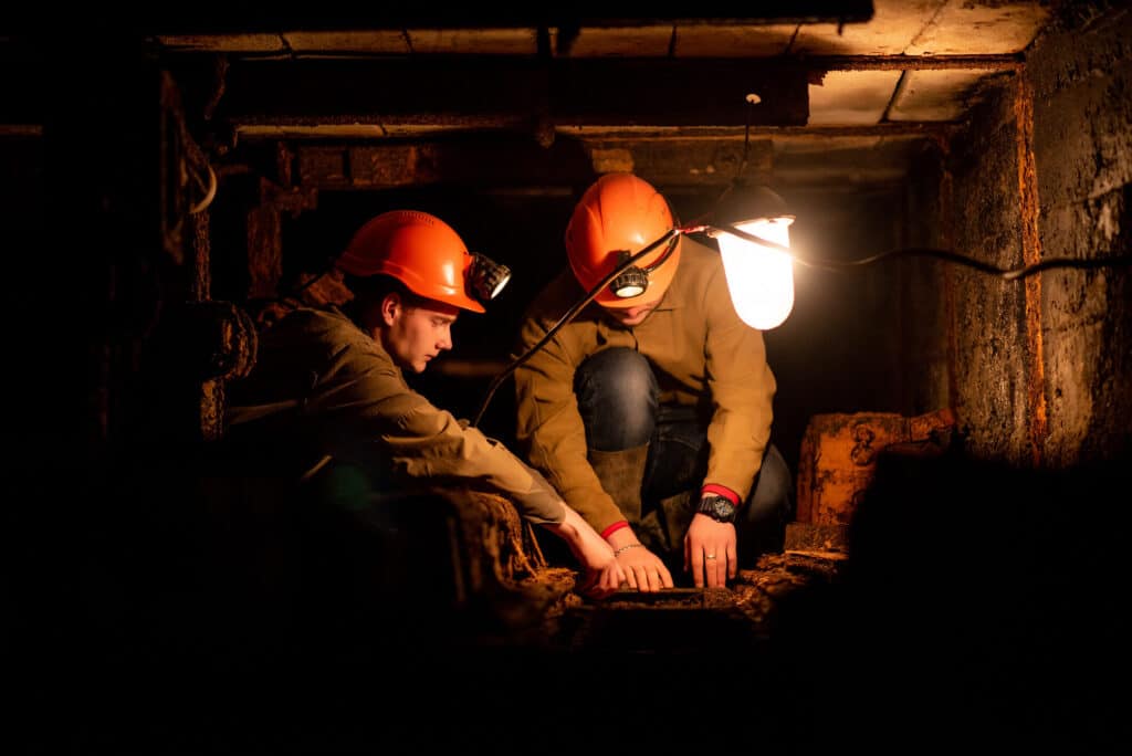 Two miners working underground