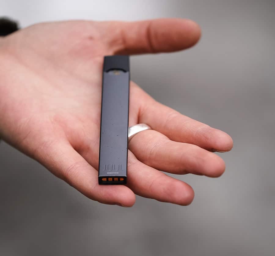 Woman holding Juul in hand