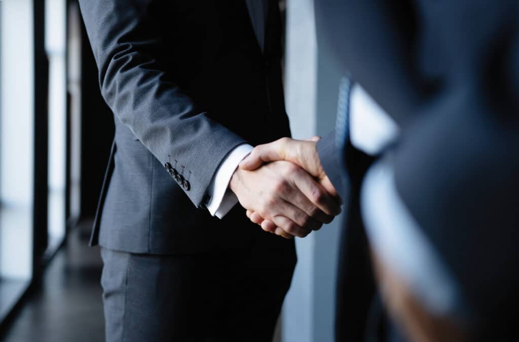 Two business people shaking hands.