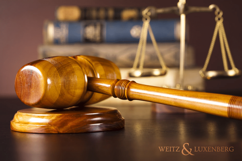 Gavel and scales of justice on a table with law books