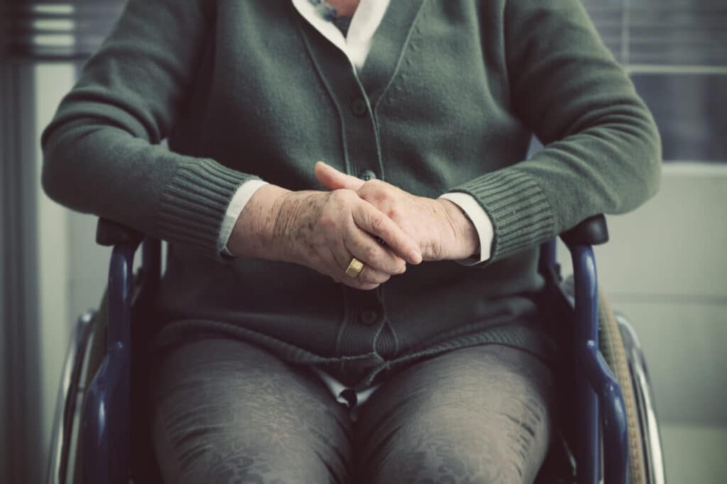 Elderly man sitting in a wheelchair.