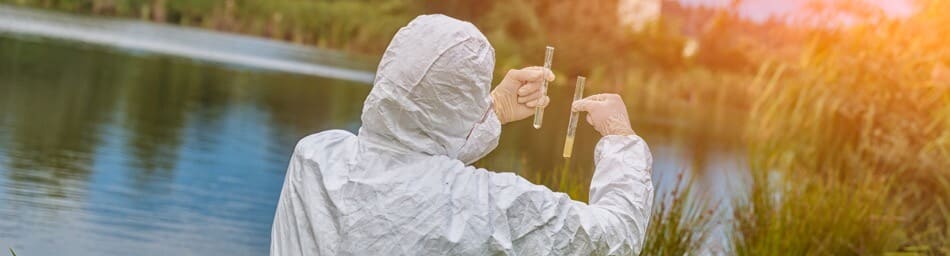 Scientist comparing vials of water