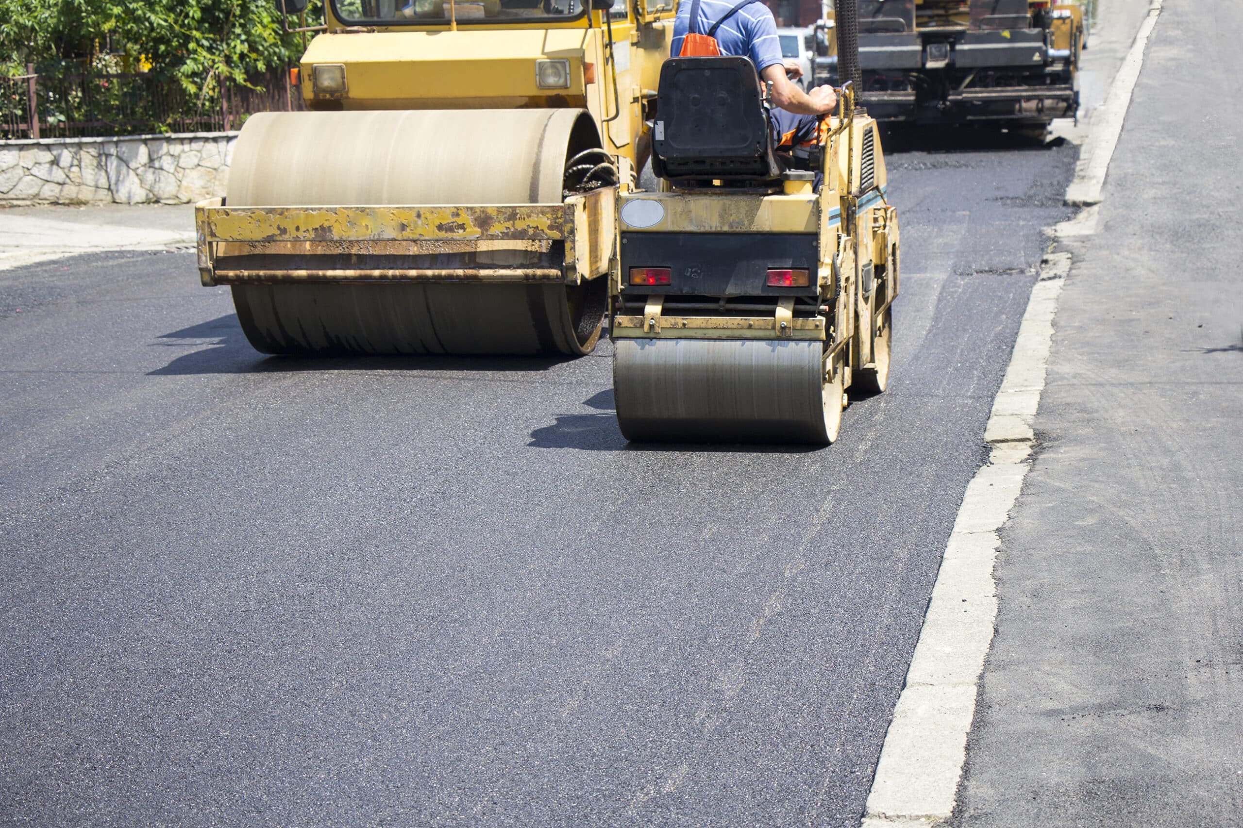 Compactor roller during road construction at asphalting work