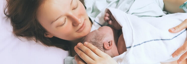 Mom holding baby after giving birth.