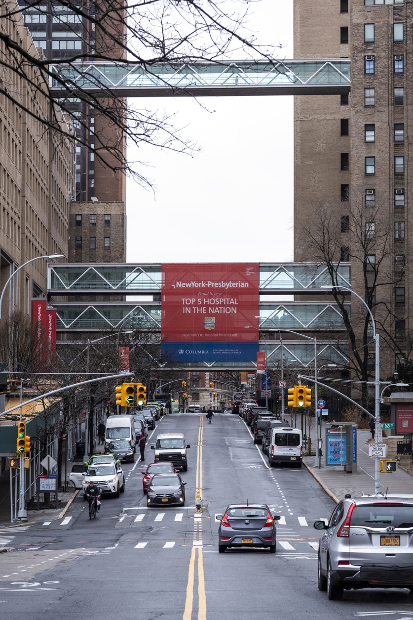 New York City, USA - March 19, 2020: View down Fort Washington Avenue, with the NewYork-Presbyterian / Columbia University Medical Center on both sides of the road, in the Washington Heights district of Manhattan.